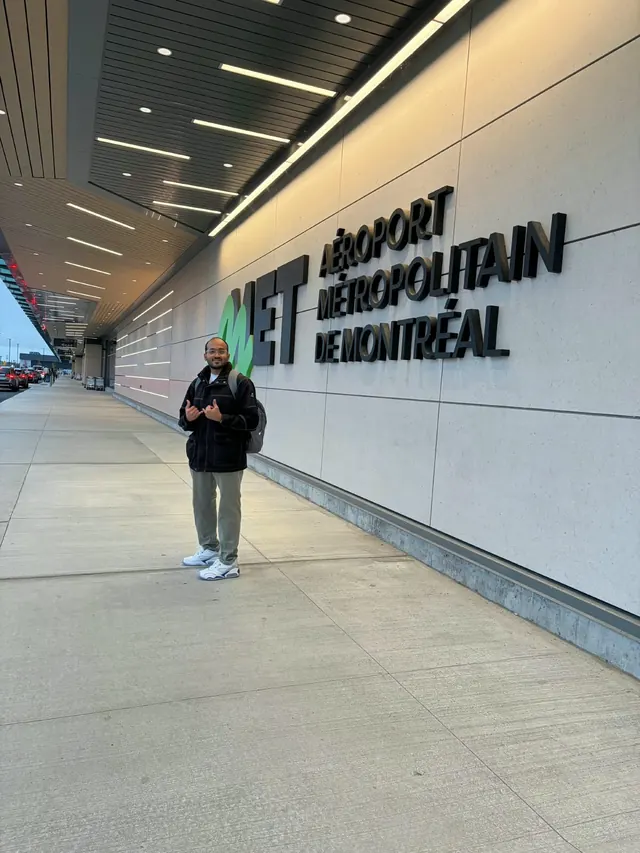 Karthik outside Montréal Metropolitan Airport (MET), next to the terminal sign